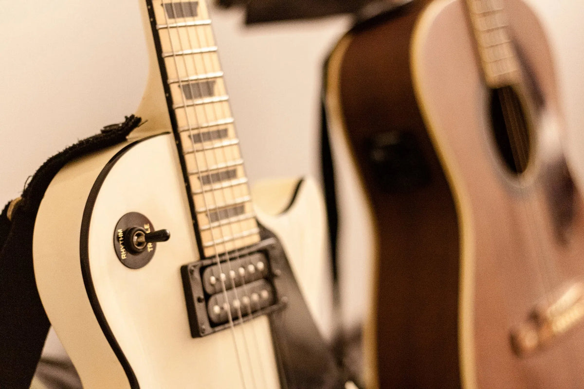 Acoustic and electric guitars side by side at DeRosa Music Bedford